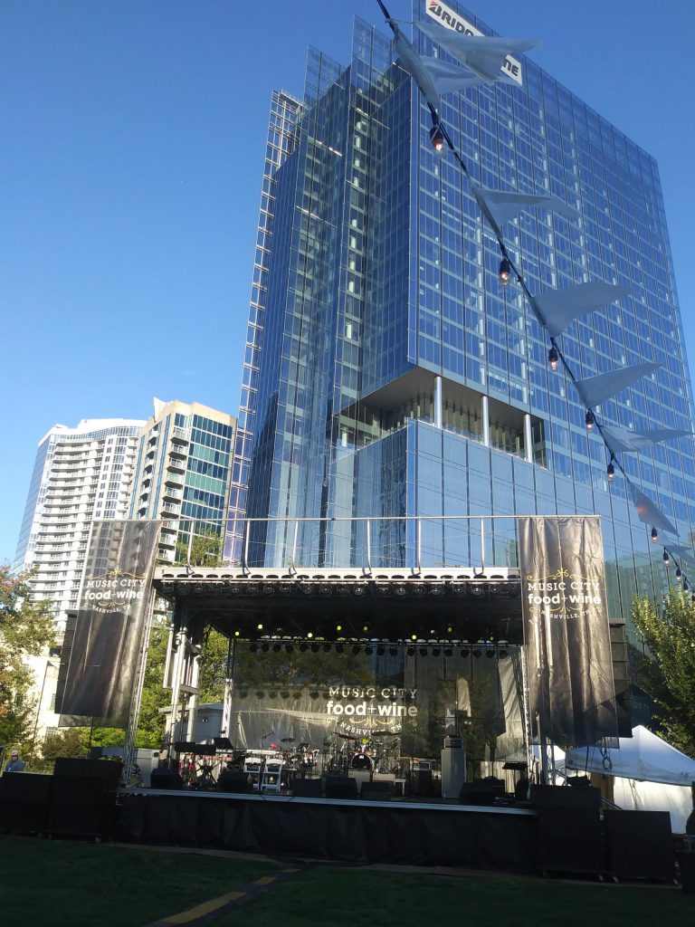Apex stage deployed at Music City Food and Wine festival against Nashville glass skyscraper