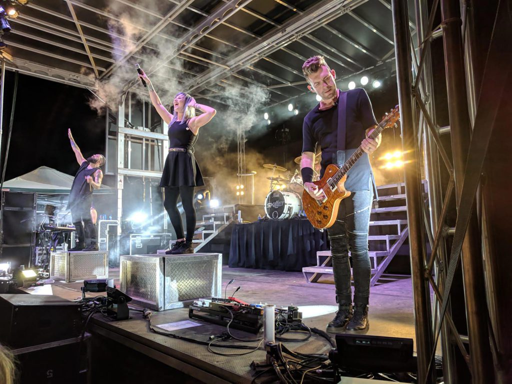 Skillet band performing on Apex stage with dramatic smoke effects at night