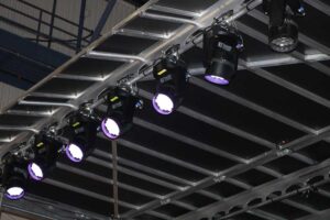 Close-up of moving head lights rigged to the roof grid of the APEX 2424 mobile stage