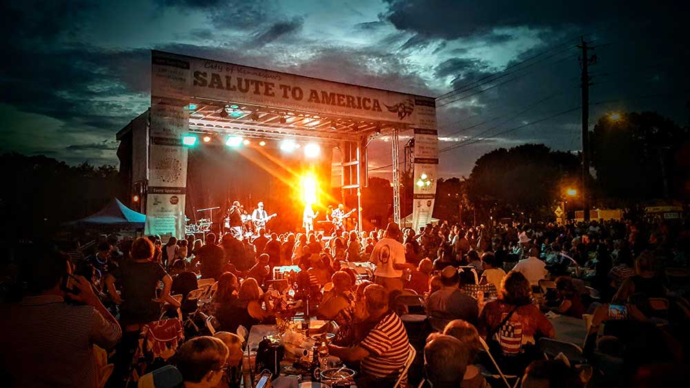 APEX 3224 GEN5 mobile stage at a Salute to America evening concert, with a large seated crowd